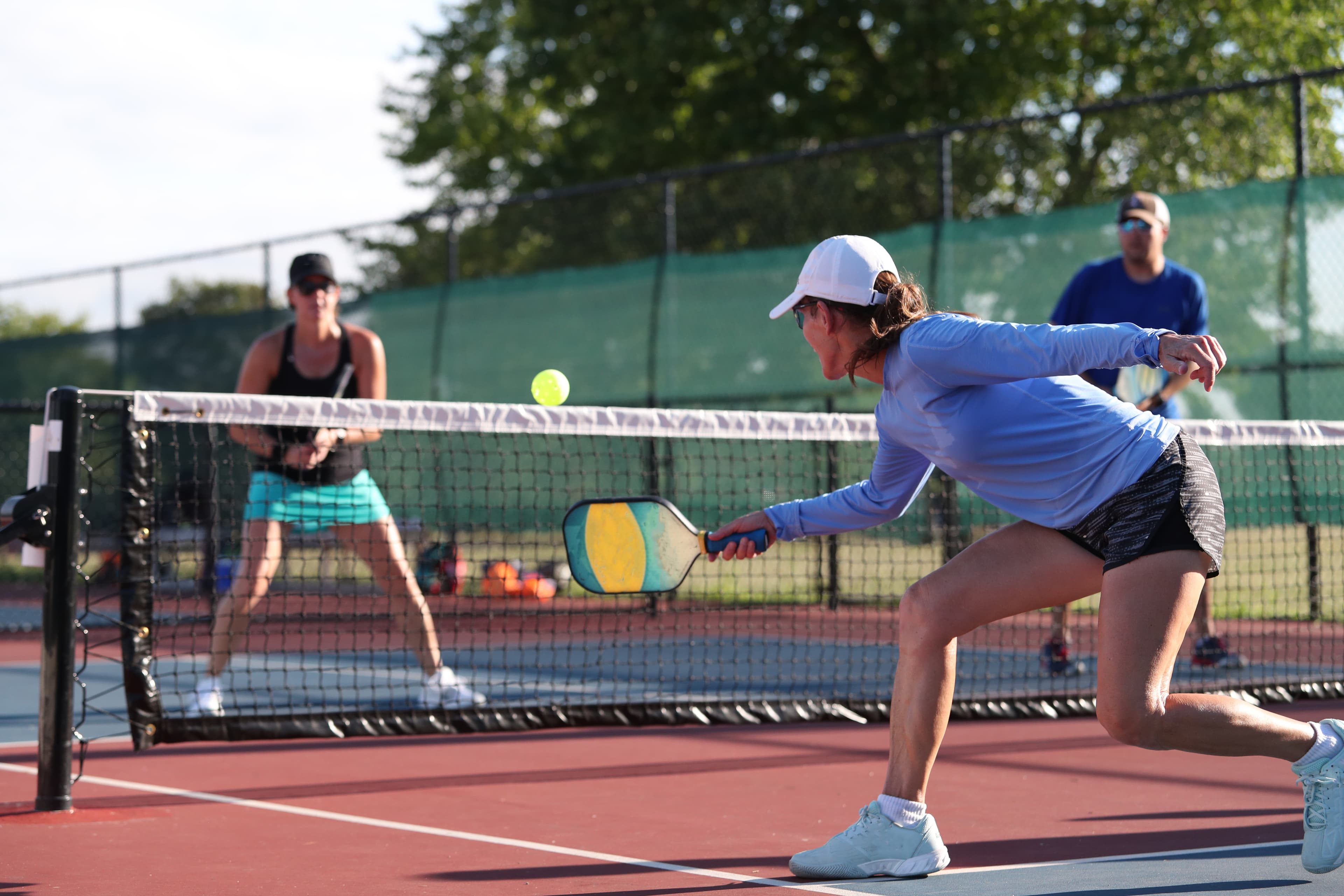 Players arranging a pickleball game courtside